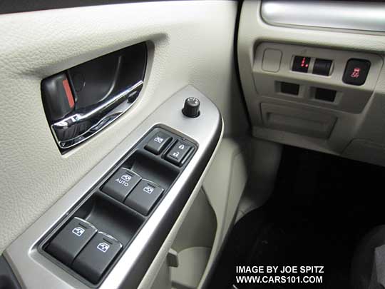 2015 Subaru Impreza Premium driver's door with bright inner door handle and bright trim tipped power window switches, Ivory interior shown