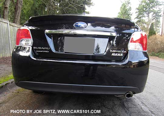 rear view, 2015 Subaru Impreza Limited 4 door sedan,  chrome trunk trim, crystal black shown