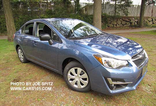 corner view quartz blue 2015 Subaru Impreza 4 door sedan, 15" steel wheel with full wheel covers, black unpainted outside mirrors, no fog lights