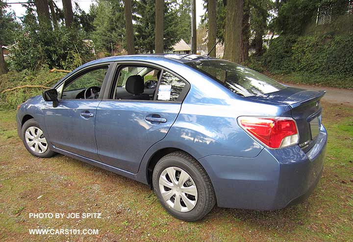 2015 Impreza 2.0i 4 door sedan, rear view. Notice the rear spoiler. Quartz blue shown