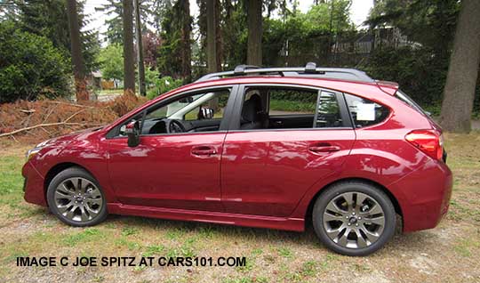 side view 2015 Impreza Sport 5 door, venetian red color.  All Sports have roof rack rails, gray alloys, turn signal mirrors...