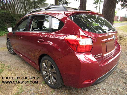 2015 Impreza rear view Sport 5 door wagon, venetian red color.  All Sports have roof rack rails, gray alloys, turn signal mirrors...