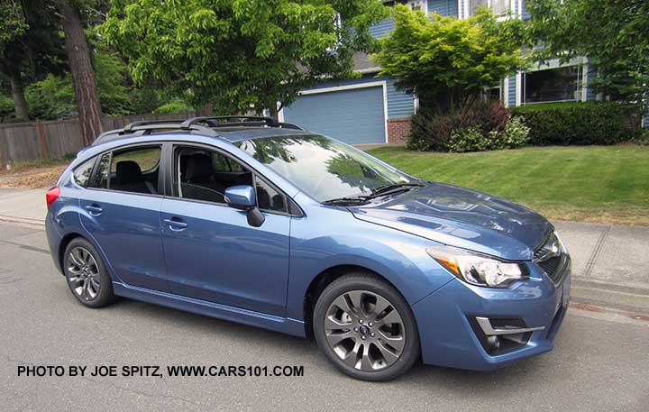 2015 Impreza Sport hatchback. Only Sport models have the roof rack rails. Gray 17" alloy wheels and turn signal mirrors are standard on Sport models. Quartz Blue shown. Quartz Blue shown