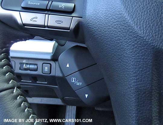 close-up of the 2015 Impreza 2.0i Limited and Sport Limited leather wrapped steering wheel with 3 buttons to control the instrument panel center LCD info display