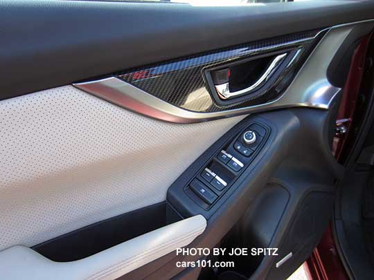 2017 Subaru Impreza Limited driver's door bright tipped power window buttons, mirror joystick, door handle, gloss door trim. Perforated ivory leather shown