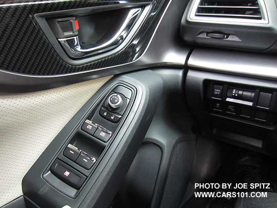 2017 Subaru Impreza Limited driver's door bright tipped power window buttons, mirror joystick, door handle, gloss door trim. Perforated ivory leather shown
