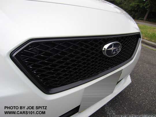 closeup of the 2017 Subaru Impreza optional front Sport Mesh Grill, center logo, showing on a crystal white Limited 4 door sedan