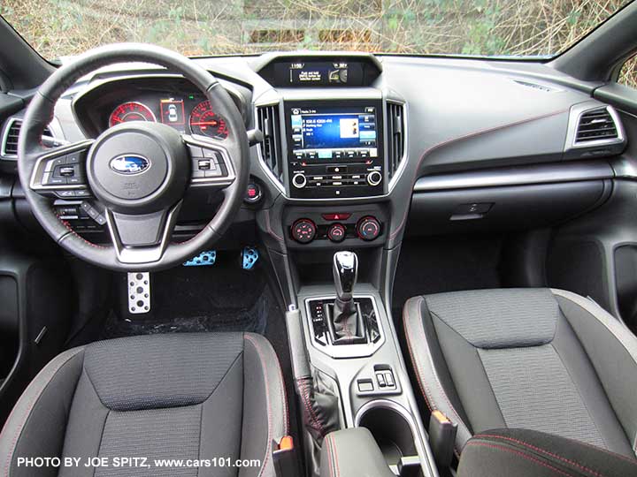 2017 Subaru Impreza Sport red lit dash gauges, black sport cloth interior with red stitching. Gloss CVT knob and surround, manual heat/ac controls, 8" audio