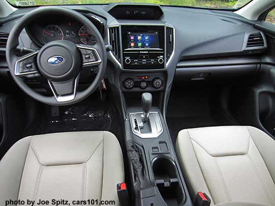 2017 Subaru Impreza 2.0i base model interior, vinyl steering wheel, 6.5" audio, no heated seat buttons,  two fixed cupholders, ivory cloth shown.