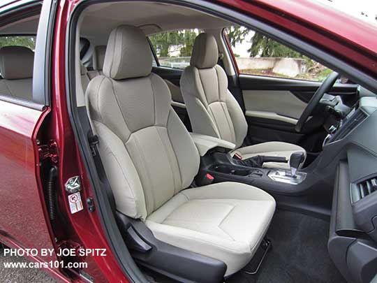 2017 Subaru Impreza 2.0i front seats, CVT with silver shift surround, no heated seat buttons, two fixed cupholders, ivory cloth shown.