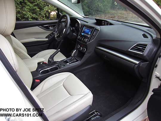 2017 Subaru Impreza Limited leather front seats, CVT with gloss black shift surround, 8" audio,  heated seat buttons, two fixed cupholders. auto climate control knobs, ivory leather shown.