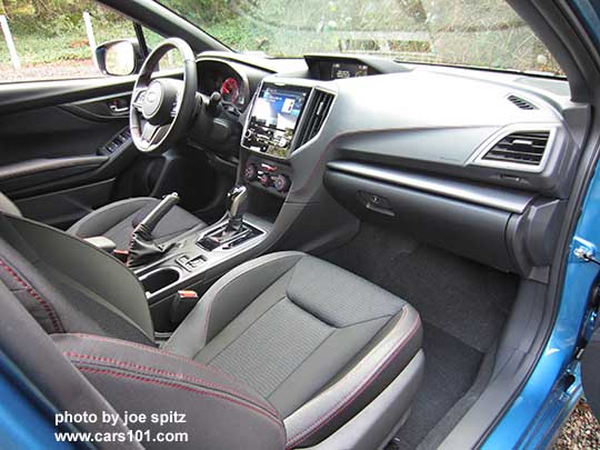 2017 Subaru Impreza Sport passenger side dash, gloss black shift surround,  and passenger seat with black sport cloth interior with red stitching