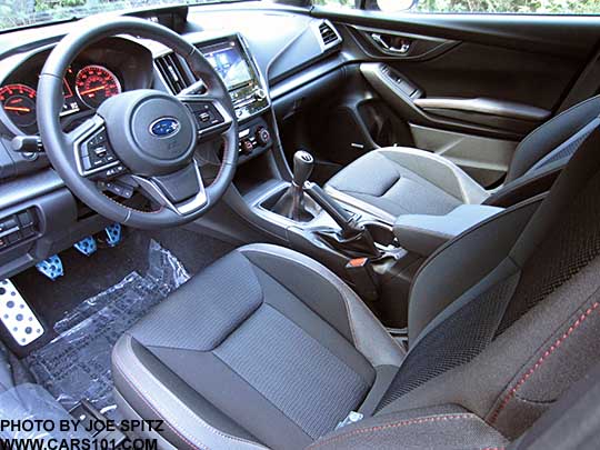 2017 Subaru Impreza Sport manual transmission interior, metal gas, brake, clutch and footrest pedal covers,  black sport cloth and leather wrapped steering wheel with red stitching