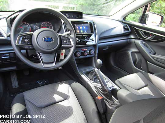 2017 Subaru Impreza 2.0i base model interior, dash and vinyl covered steering wheel, manual transmission shown