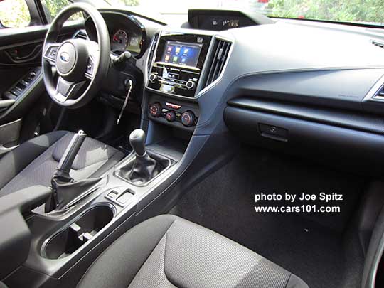 from driver's side 2017 Subaru Impreza 2.0i base model interior, passenger seat, manual transmission shown