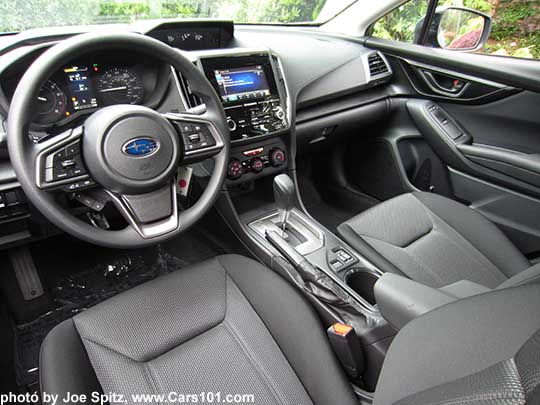 2017 Subaru Impreza Premium interior. Black cloth, vinyl covered steering wheel, silver shift plate, heated seat buttons, 6.5" audio
