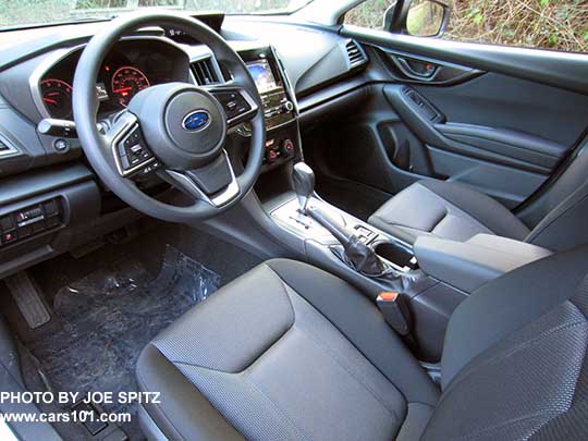 2017 Subaru Impreza Premium dash, vinyl steeering wheel, silver shift surround,  black cloth driver's seat shown