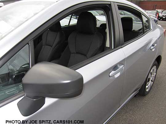 2017 Subaru Impreza 2.0i base model 4 door sedan outside mirror is unpainted black. Shown on an ice silver car, black cloth interior.
