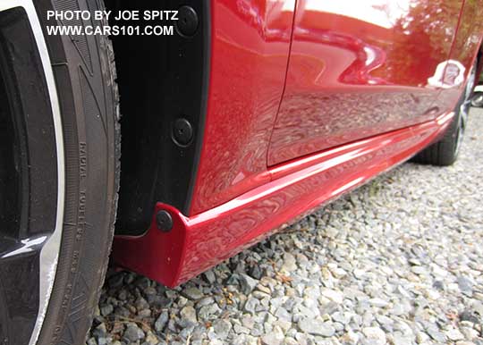closeup up of the 2017 Subaru Impreza Sport rocker panel trim, body colored. Front toward rear. Lithium red shown