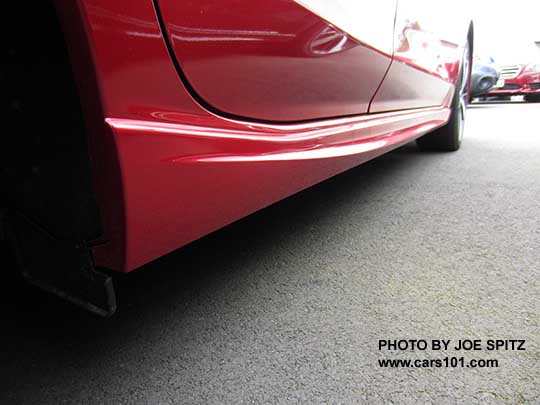 2017 Subaru Impreza Sport lower rocker panel with extra trim piece only available on the Sport 4 and 5 door. Lithium red car shown. Rear looking toward front.