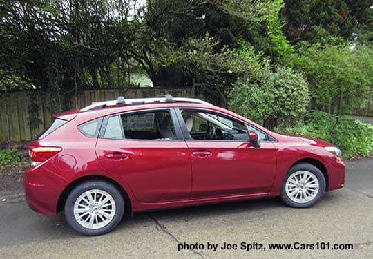 2017 Subaru Impreza Premium 5 door hatchback, body colored door handles and mirrors, 16" silver alloys, silver roof rack rails and optional aero cross bars. Venetian Red car shown