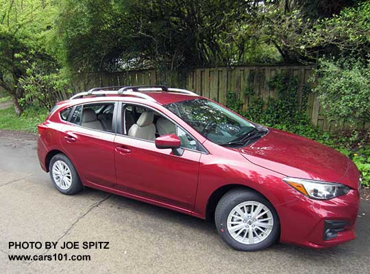 2017 Subaru Impreza Premium 5 door hatchback, body colored mirrors and door handles, 16" silver alloys, silver roof rack rails with optional aero cross bars. Venetian Red car shown