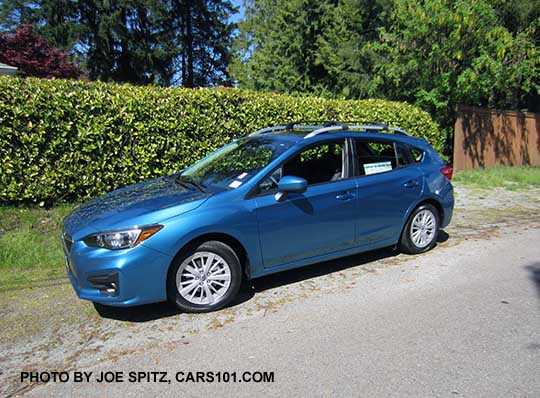 2017 Subaru Impreza 5 door hatchback. Island blue pearl color. with 16" silver alloys, silver roof rack rails, body color door handles and mirrors. With optional aero roof rack crossbars