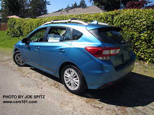 side view 2017 Subaru Impreza 5 door hatchback. Island blue pearl color. with 16" silver alloys, silver roof rack rails, body color door handles. Optional roof rack aero crossbars.