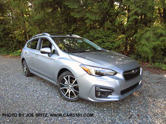 2017 Subaru Impreza Limited 5 door hatchback has 17" machined alloys, silver fog light trim, silver roof rack rails, silver door handles. Ice silver color shown.