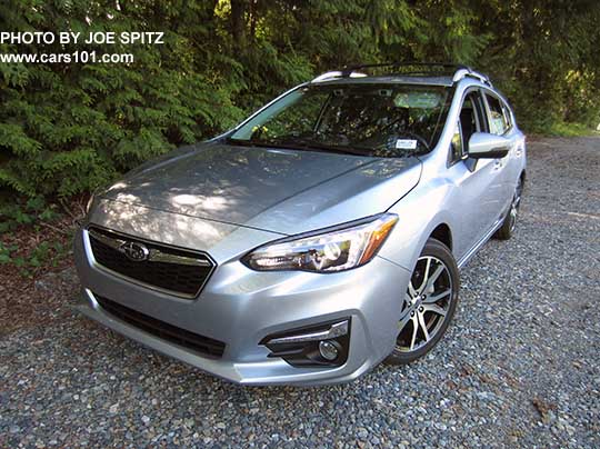 2017 Subaru Impreza Limited 5 door hatchback has 17" machined alloys, silver fog light trim, silver roof rack rails with optional crossbars. Ice silver color shown.