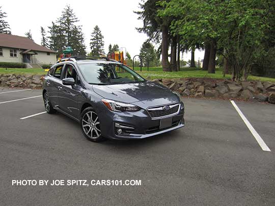 2017 Impreza Limited 5 door hatchback, carbide gray color, has machined 17" alloys, silver fog light trim, roof rack rails and door handles. Shown with optional aero cross bars.