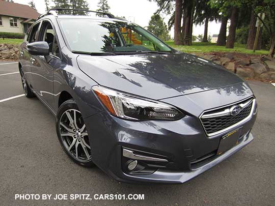 2017 Impreza Limited 5 door hatchback, carbide gray color, has machined 17" alloys, silver fog light trim, and roof rack rails. Shown with optional aero cross bars