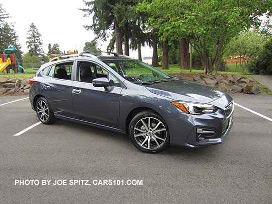 2017 Impreza Limited 5 door hatchback, carbide gray color, has machined 17" alloys, silver fog light trim, roof rack rails and door handles. Shown with optional aero cross bars