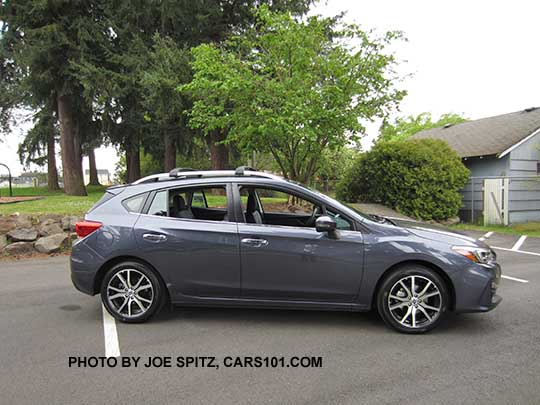 2017 Impreza Limited 5 door hatchback, carbide gray color, has machined 17" alloys, silver roof rack rails and door handles. Shown with optional aero cross bars