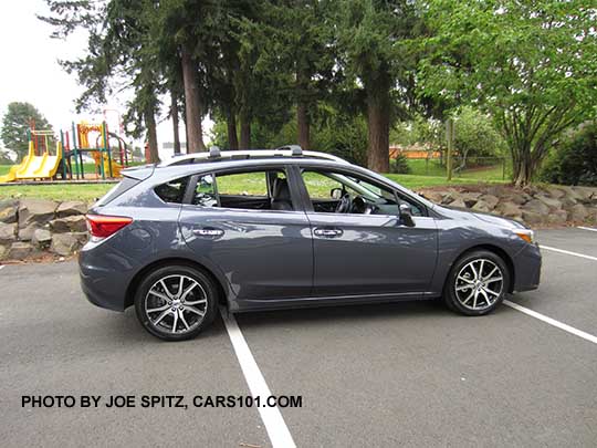 2017 Impreza Limited 5 door hatchback, carbide gray color, has machined 17" alloys, silver roof rack rails and door handles. Shown with optional aero cross bars