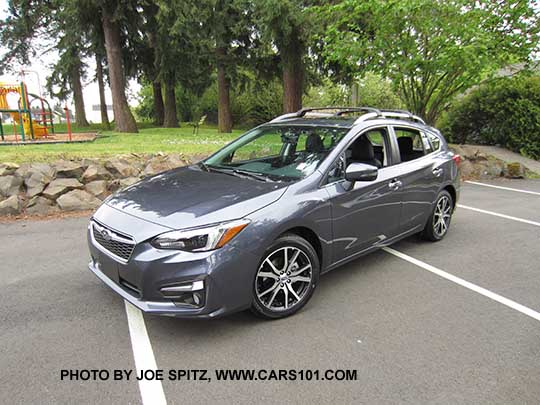 2017 Impreza Limited 5 door hatchback, carbide gray color, has machined 17" alloys, silver fog light trim, roof rack rails and door handles. Shown with optional aero cross bars.