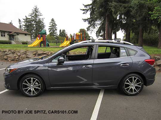 2017 Impreza Limited 5 door hatchback, carbide gray color, has machined 17" alloys, silver fog light trim, roof rack rails and door handles. Shown with optional aero cross bars.