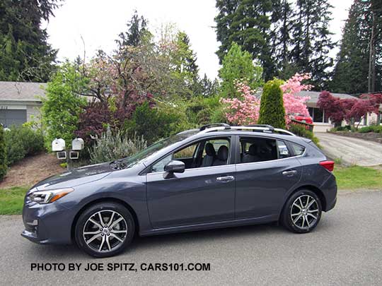 2017 Impreza Limited 5 door hatchback, carbide gray color, has machined 17" alloys, silver roof rack rails and door handles. Shown with optional aero cross bars.