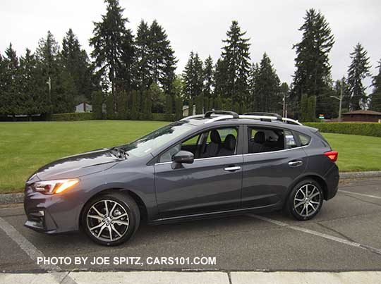2017 Impreza Limited 5 door hatchback, carbide gray color, has machined 17" alloys, silver fog light trim, roof rack rails and door handles. Shown with optional aero cross bars.