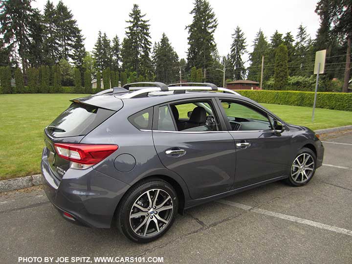 2017 Impreza Limited 5 door hatchback, carbide gray color, has machined 17" alloys, silver roof rack rails and door handles. Shown with optional aero cross bars.