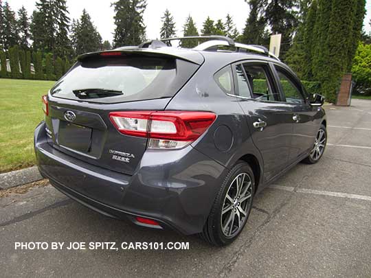 rear view 2017 Impreza Limited 5 door hatchback, carbide gray color, has machined 17" alloys, silver door handles and roof rack rails. Shown with optional aero cross bars.