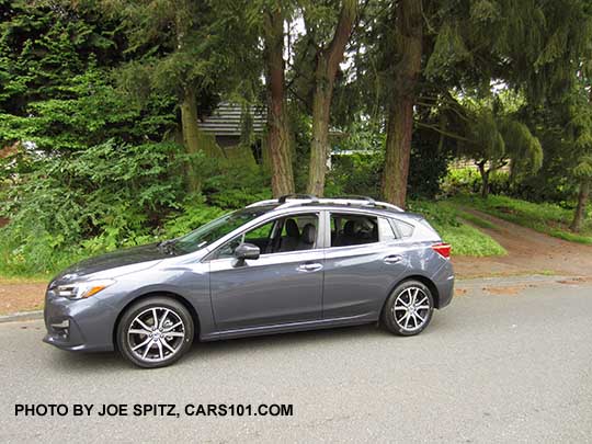 2017 Impreza Limited 5 door hatchback, carbide gray color, has machined 17" alloys, silver roof rack rails and door handles. Shown with optional aero crossbars.
