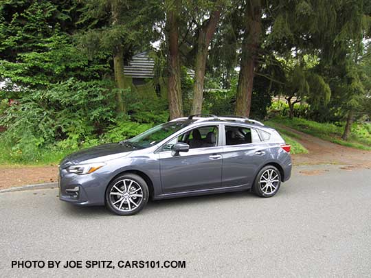 2017 Impreza Limited 5 door hatchback, carbide gray color, has machined 17" alloys, silver fog light trim, roof rack rails and door handles. Shown with optional aero crossbars.