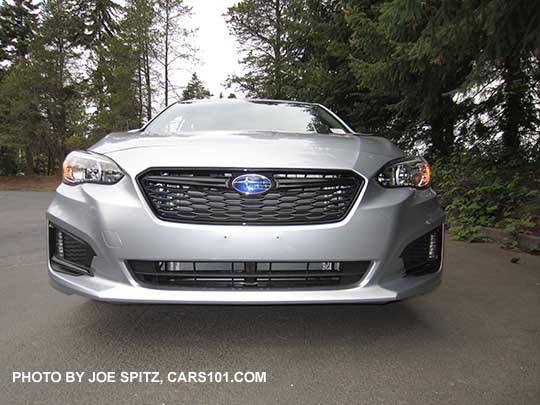 2017 ice silver Subaru Impreza Sport 5 door hatchback. 18" machined alloys, LED daytime running lights, silver door handles, body colored mirrors with turn signals. No roof rack rails