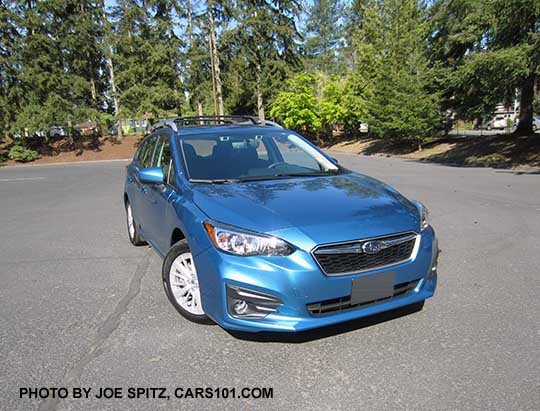 2017 Subaru Impreza Premium 5door hatchback, Island Blue color. 16" silver alloys, silver roof rack rails, body colored mirror. With optional Eyesight cameras by the rear view mirrors, fog lights (incl with Eyesight), and aero crossbars.