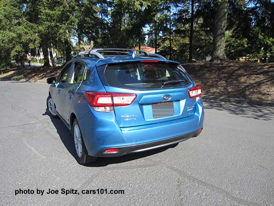 rear view 2017 Subaru Impreza Premium 5door hatchback, Island Blue color. 16" silver alloys, silver roof rack rails. With optional aero crossbars