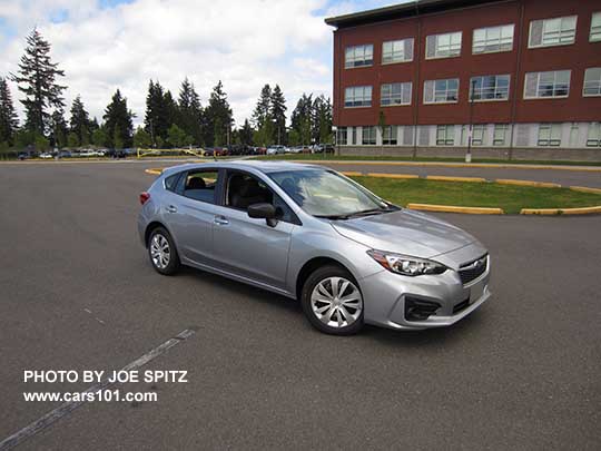 2017 Subaru Impreza 2.0i 5 door hatchback base model, steel wheels with wheel covers, unpainted black outside mirror, no roof rails. Ice silver shown