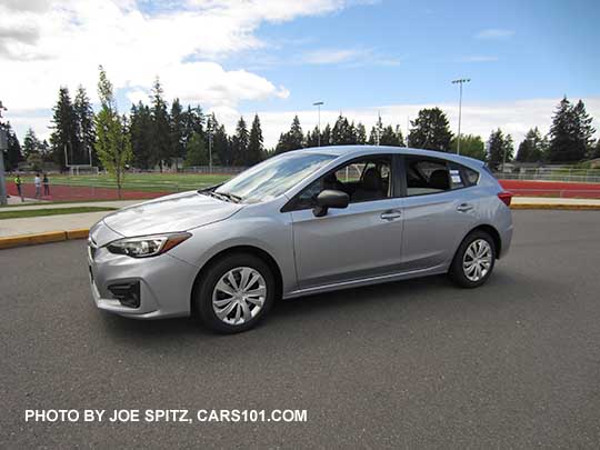 2017 Subaru Impreza 2.0i base model 5 door hatchback, ice silver shown. Steel wheels with covers, unpainted mirrors, no roof rails.