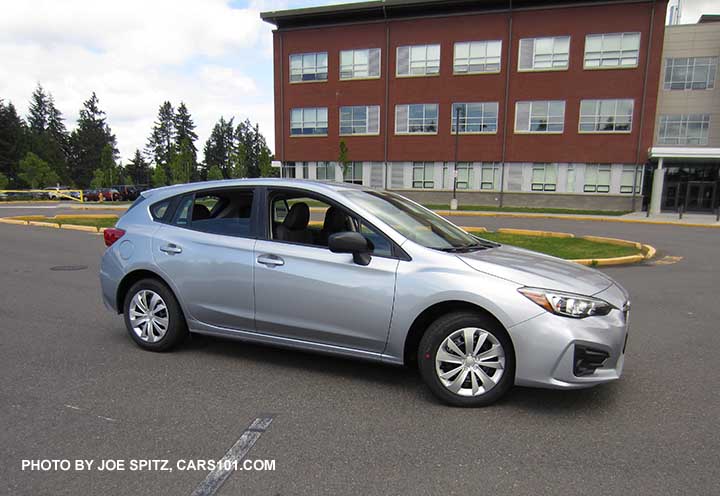 2017 Subaru Impreza 2.0i 5 door hatchback base model, steel wheels with wheel covers, unpainted black outside mirrors, no roof rails. Ice silver shown