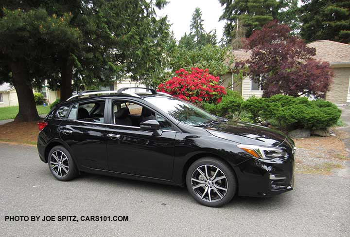 crystal black 2017 Subaru Impreza Limited 5 door hatchback body has silver door handles, silver lower window trim,  silver roof rails, silver fog light trim, body colored outside mirror with turn signals, 17" machined alloys. Optional cross bars.